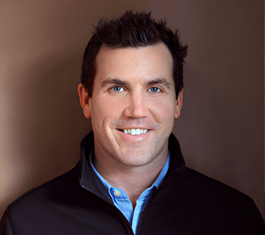Chris Dudick has short brown hair and is smiling at the camera.
