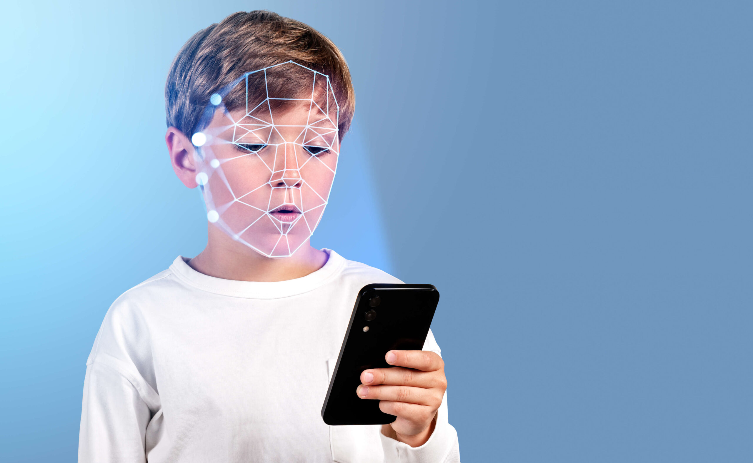 A child looking at a phone screen with dots and lines overlayed on his face.